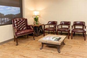 front office of Bellaire Dental Excellence with table, chairs and art on wall